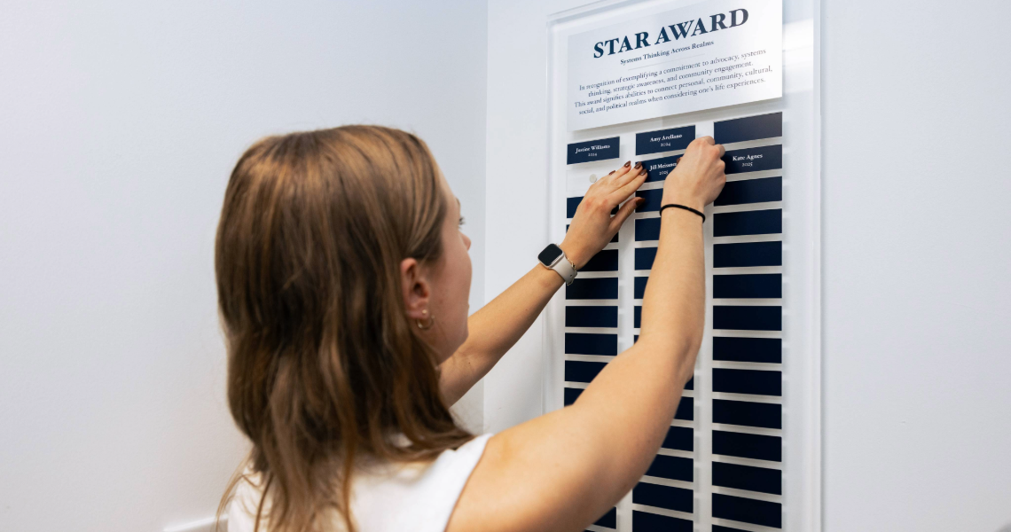 Student Placing Name on Plaque