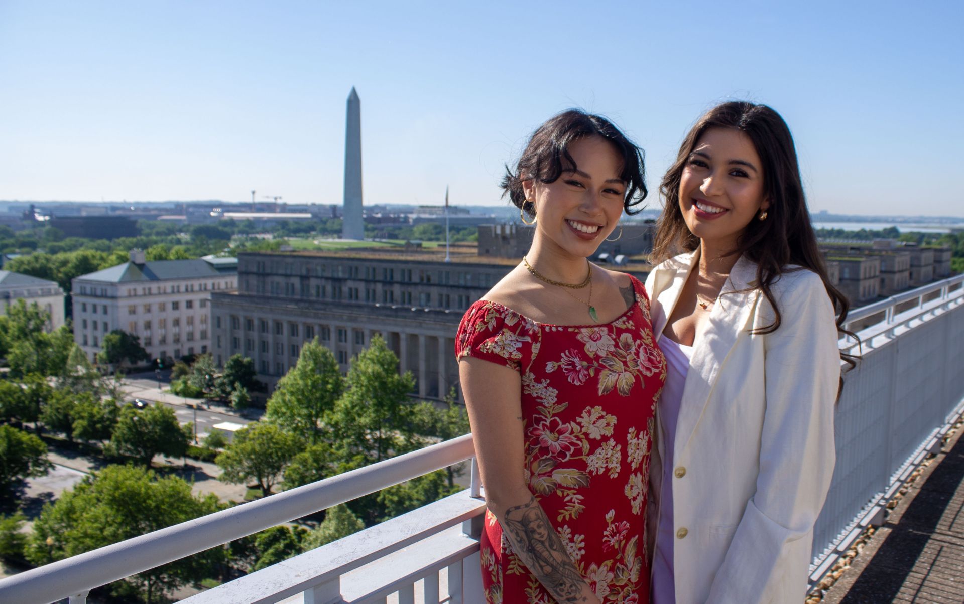 two students smiling on balcony