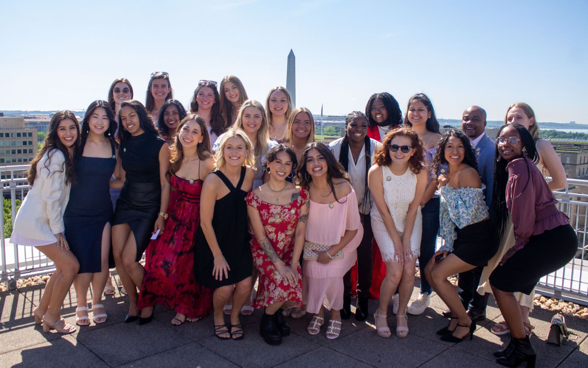 gw ot group photo on balcony with washington monument in background