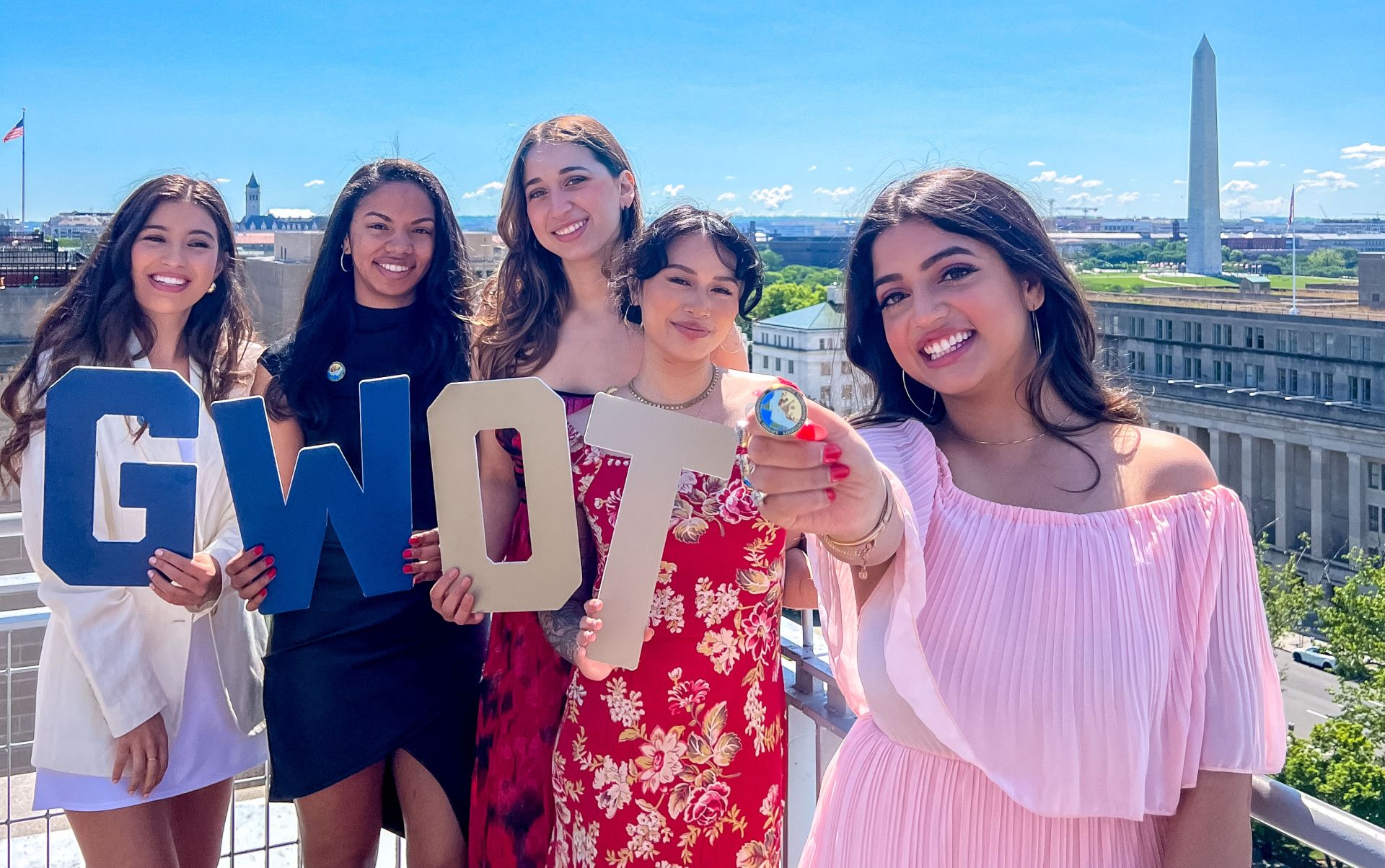 gw ot students holding pin and letters on balcony