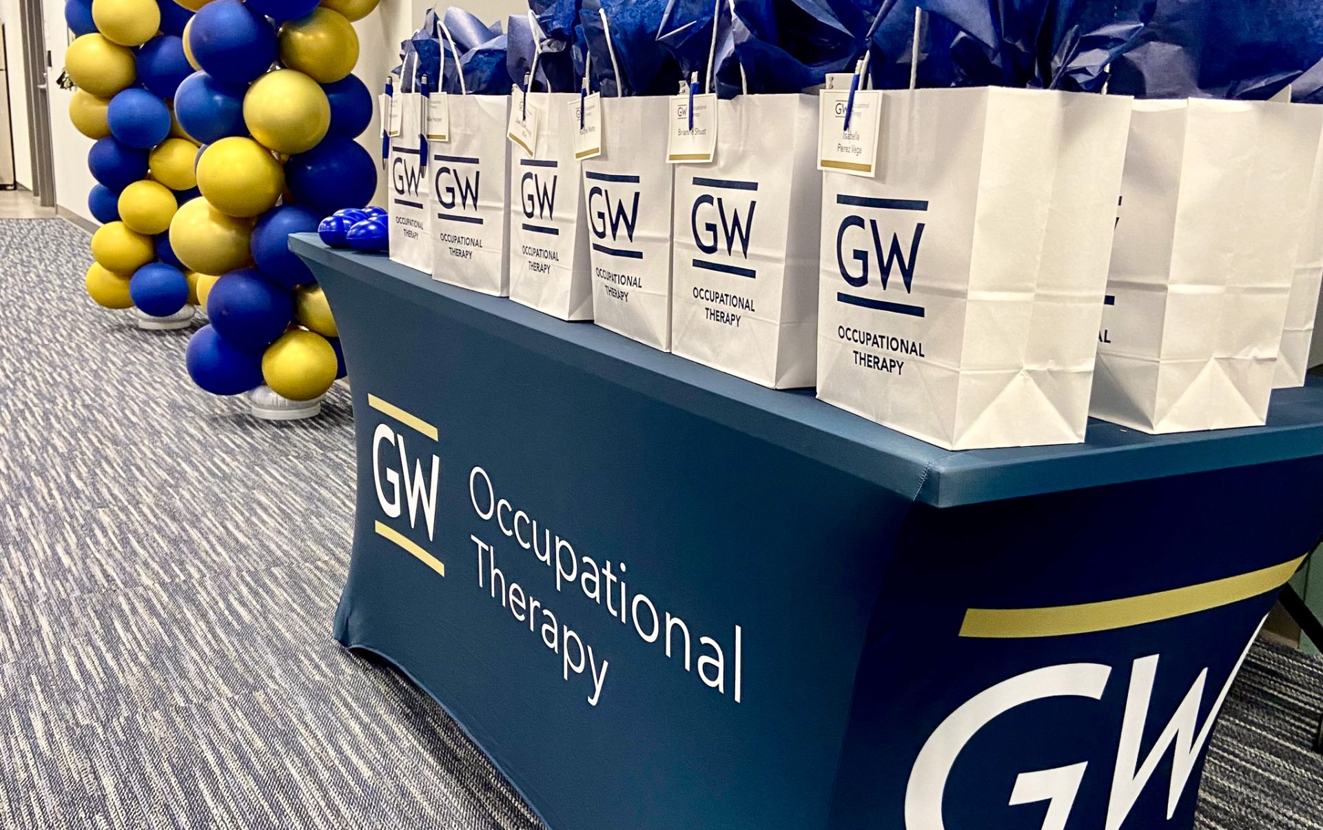 GW table cloth with branded bags on top