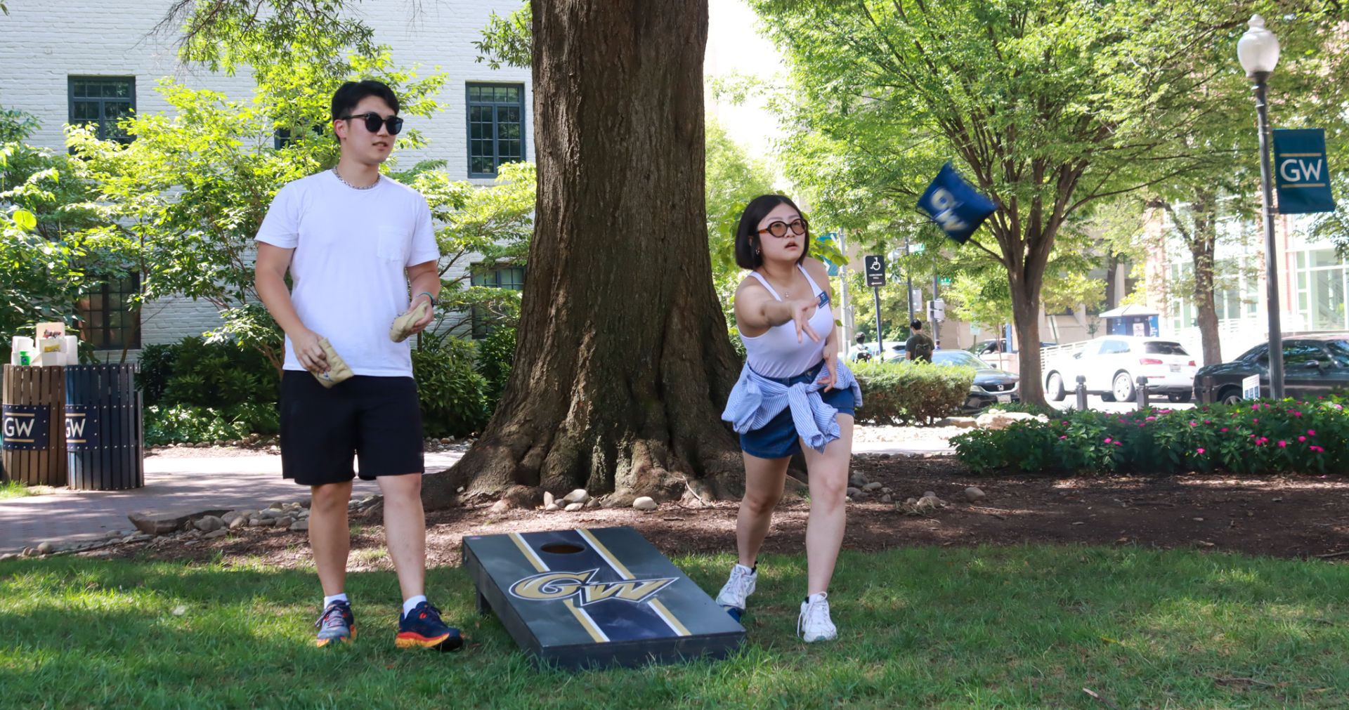 students playing cornhole outside