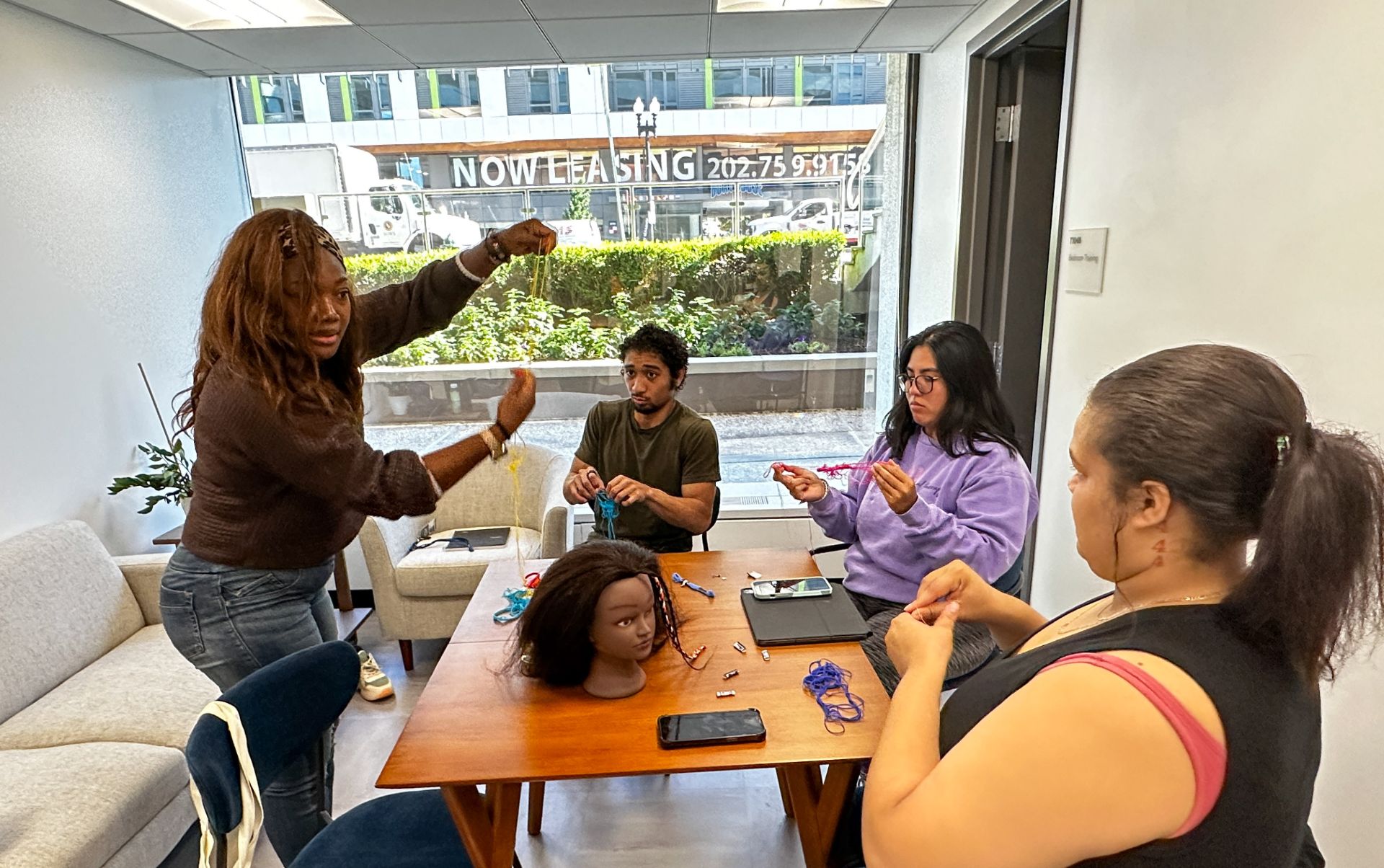 Students adding to a hair wig