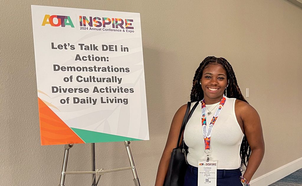 Collese Daly smiling in front of Workshop on DEI poster