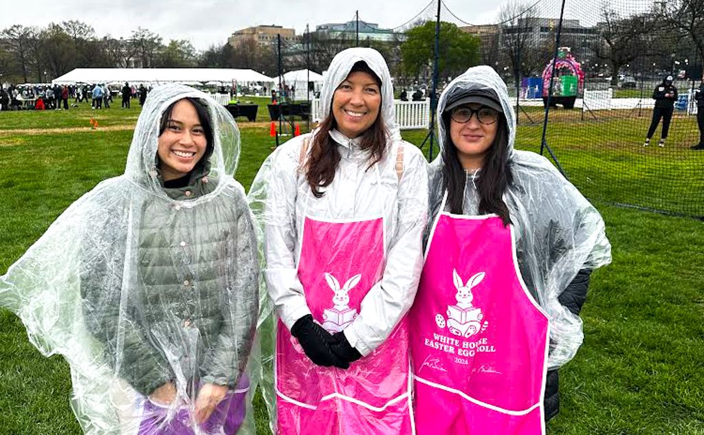 OT Student Isabele with Dr. Moyle and Erica Fuentes similing in rain coats