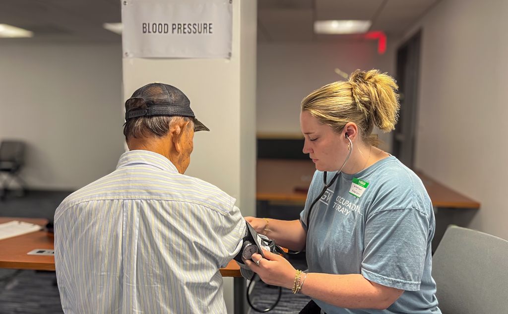 Meghan Moriarty conducting blood pressure screen