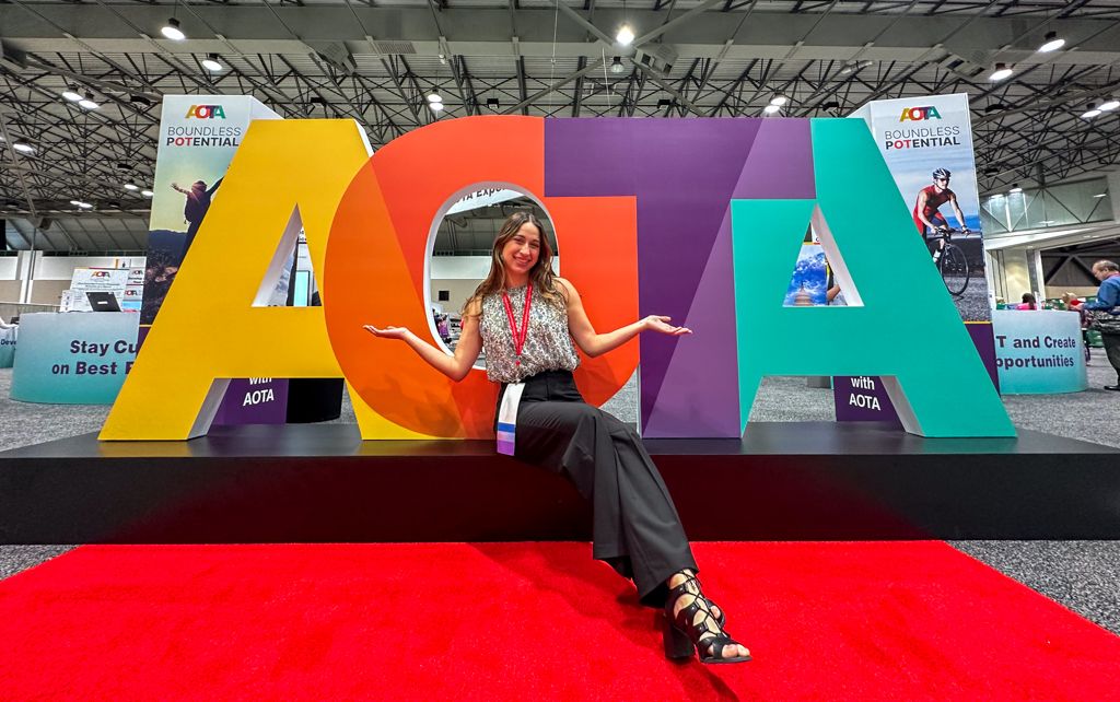 AOTA Natalia in front of big letters