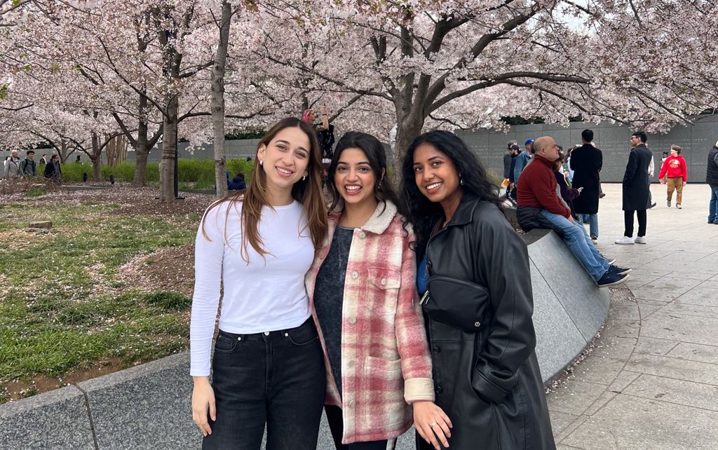 Natalia Anzaldúa Ayala with friends in front of Cherry Blossoms