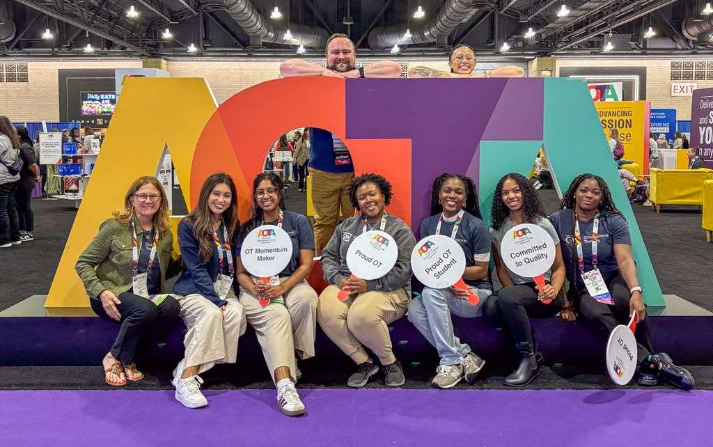 OT Students with AOTA Sign and Props