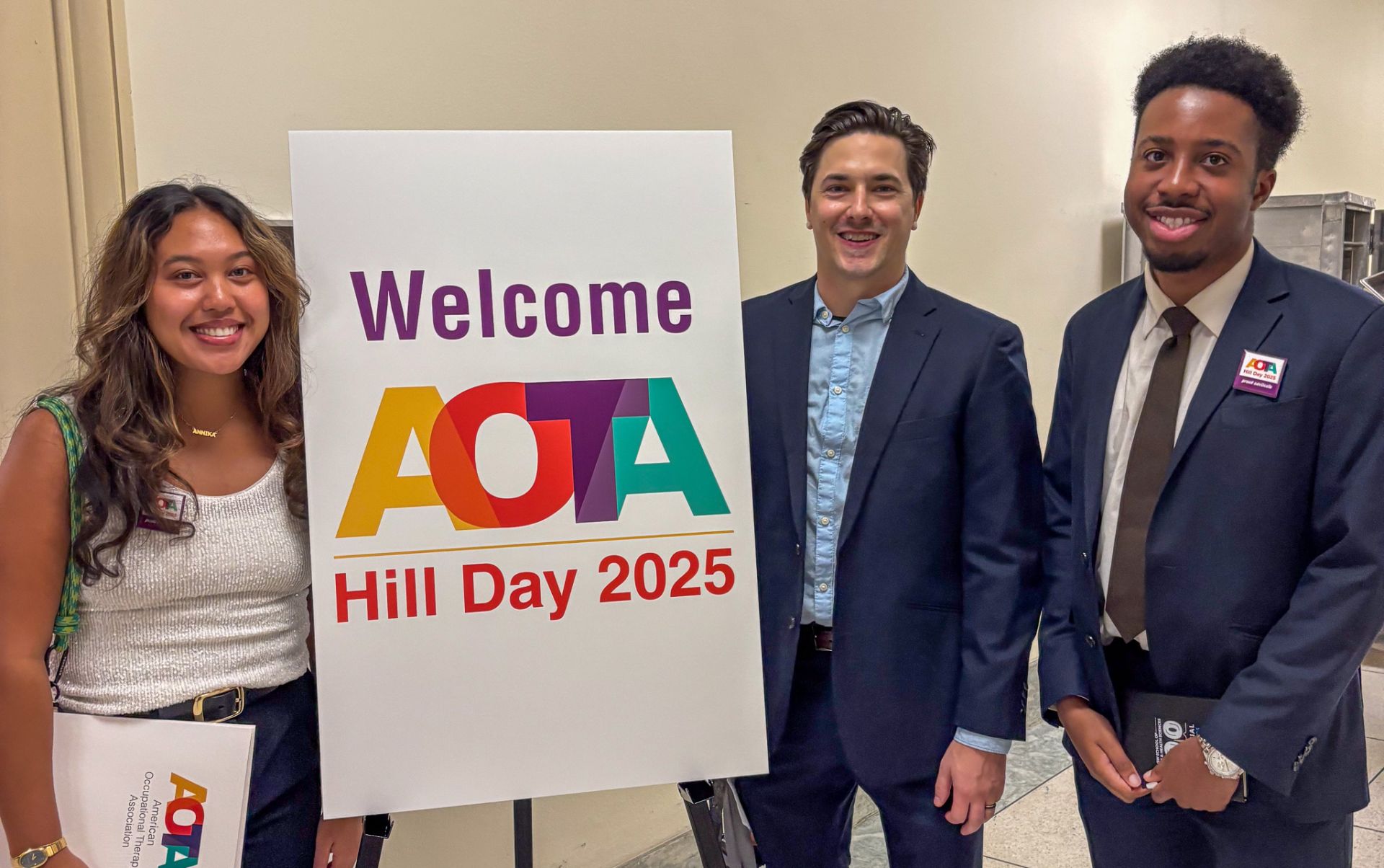 GW OT Students smiling with Welcome to AOTA Hill Day 2025 sign