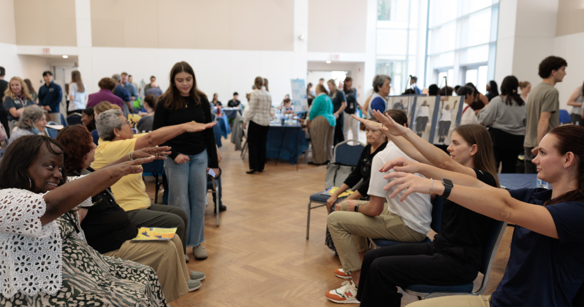 Older adults doing seated exercise at Falls Prevention Awareness Day