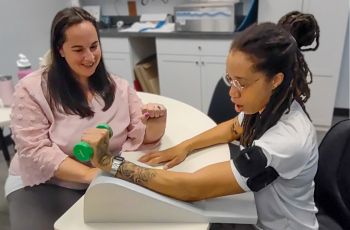 GW OT Instructor Jill Yanick providing blood flow restriction training