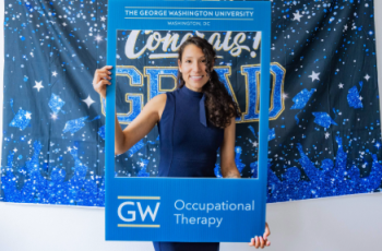Carolin Capurro Perez with GW OTD sign